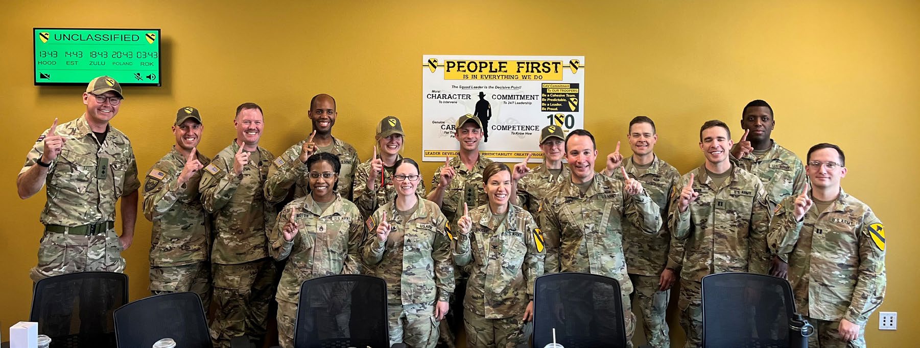 Members of the 3rd United Kingdom Legal Branch (wearing 1st Cavalry Division baseball hats) pose with members of the 1st Cavalry Division Office of the Staff
      Judge Advocate after Exercise WARFIGHTER 23.4 at Fort Cavazos, Texas. (Photo courtesy of author)